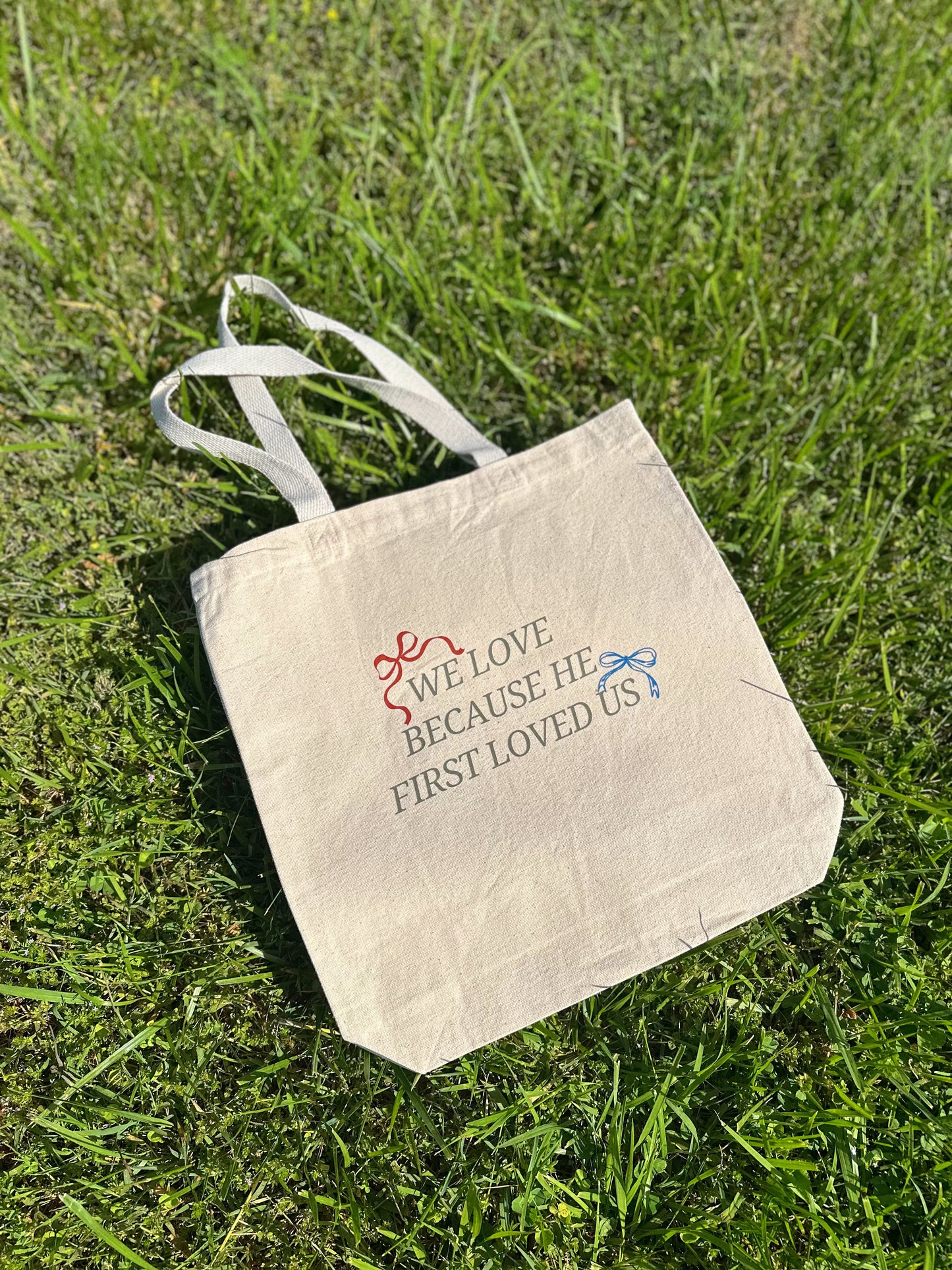 We Love Because He First Loved Us Tote Bag